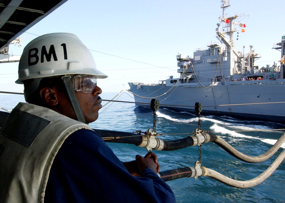 US Navy 040917-N-4374S-004 Boatswain's Mate 1st Class Willie McArthur assigned to the aircraft carrier USS John F. Kennedy (CV 67), observes a replenishment at sea