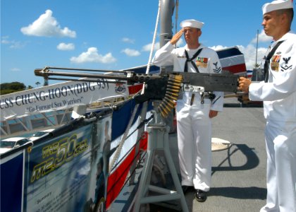 US Navy 040918-N-3019M-001 Gunner's Mate 2nd Class John Valenzuela renders a 19-gun salute aboard the Navy's newest Arleigh Burke-class guided missile destroyer USS Chung-Hoon (DDG 93)