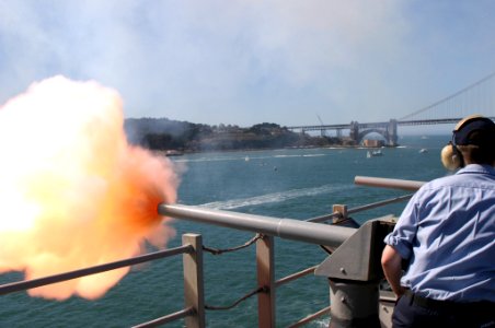 US Navy 041009-N-2379C-070 Gunner's Mate Seaman William Sanders, of San Jose, Calif., fires a 40mm Saluting Battery from the signal bridge aboard the amphibious assault ship USS Tarawa (LHA 1) photo