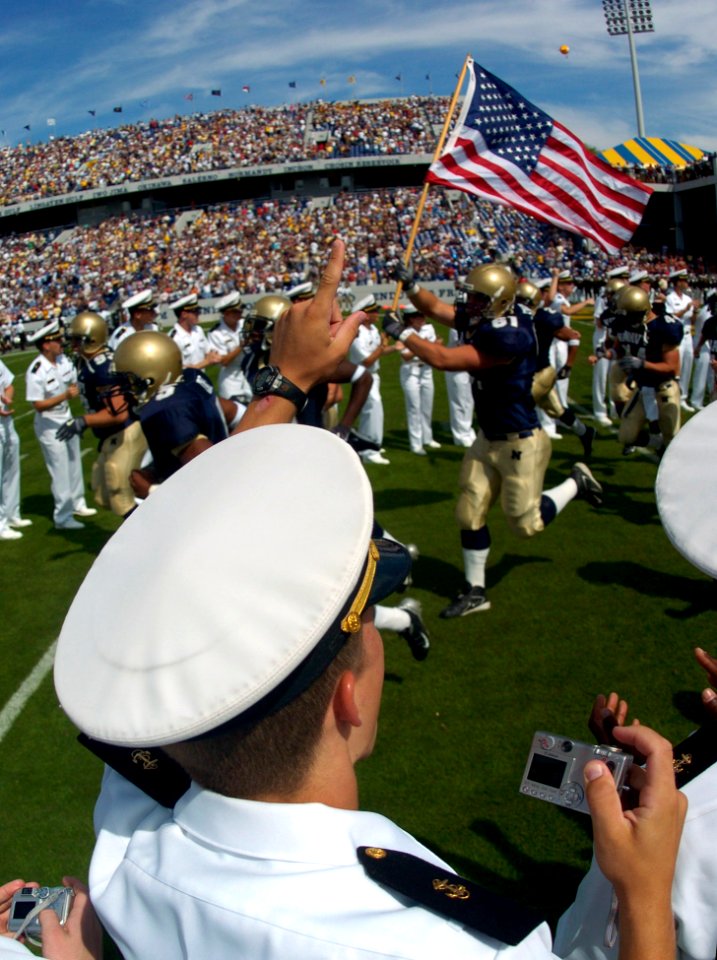 US Navy 040925-N-9693M-001 U.S. Naval Academy Midshipman cheer as their football team runs onto the field prior to a game against Vanderbilt