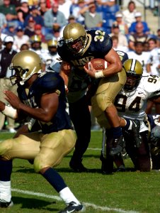 US Navy 040925-N-9693M-012 U.S. Naval Academy Midshipman 1st Class Kyle Eckel rushes through a pile of Vanderbilt defenders enroute to a two-point conversion run to put Navy up 22-19 midway through the third quarter