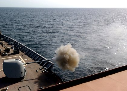 US Navy 041025-N-4374S-001 The guided missile cruiser USS Vicksburg (CG 69) fires a high explosive control variable round from an MK-45 (5-54 caliber) lightweight gun during a live fire exercise in the Arabian Gulf photo