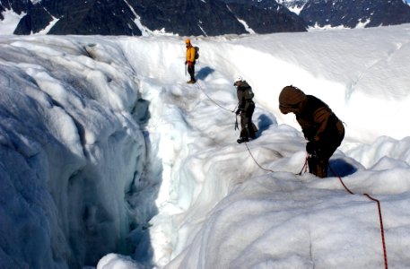 US Navy 040810-N-0331L-002 Chief Aviation Mishap Investigator for the Naval Safety Center, Cdr. Charles Huff and Mountain Guide, Philip Poole cross a crevasse to locate the wreckage of LA-9 a Navy P-2V Neptune aircraft