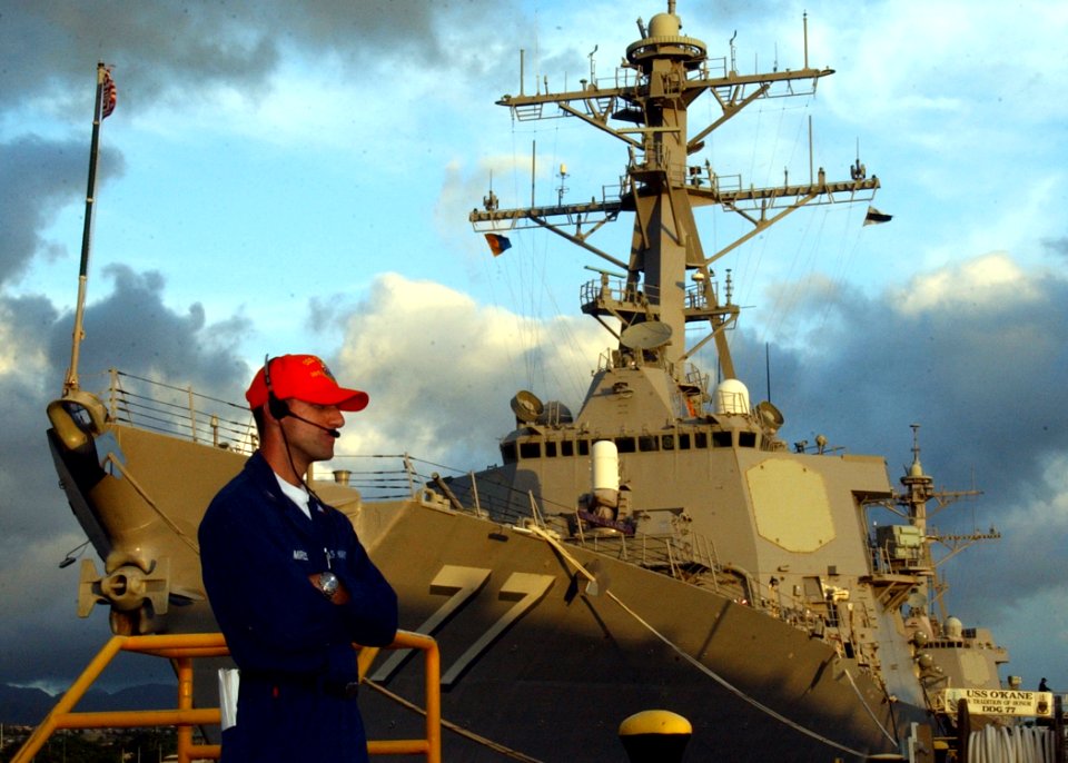 US Navy 041028-N-3019M-003 Gas Turbine System Mechanical 2nd Class Mario Ramirez, assigned to the Arleigh Burke-class guided missile destroyer USS Chafee (DDG 90), watch a group of simulated demonstrators