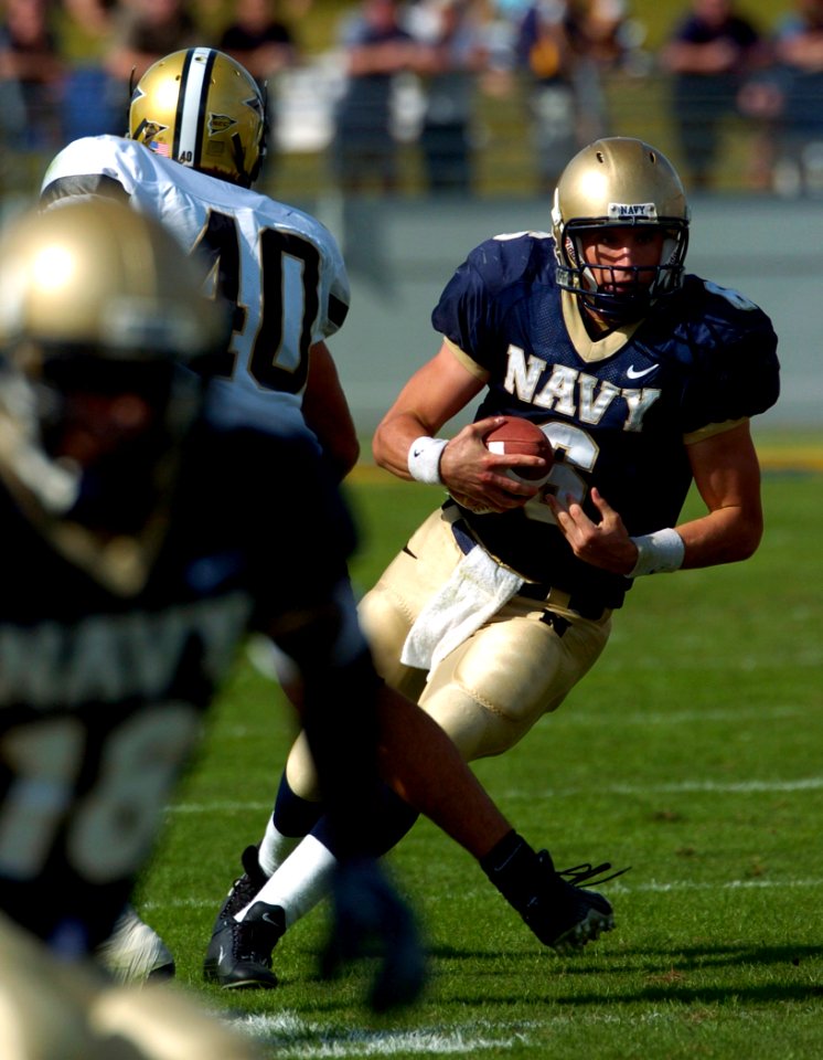US Navy 040925-N-9693M-008 U.S. Naval Academy Midshipman 21st Class Aaron Polanco evades Vanderbilt linebacker Kevin Joyce