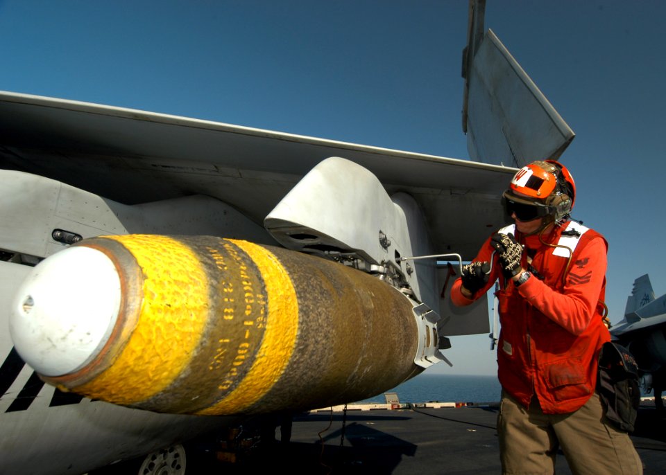 US Navy 041004-N-8704K-002 An Aviation Ordnanceman conducts final maintenance after loading a satellite-guided Joint Direct Attack Munition (JDAM)
