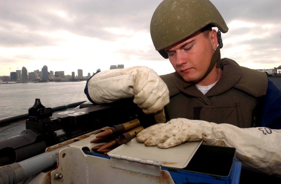 US Navy 040928-N-8158F-128 Aviation Ordnanceman 3rd Class Charles Wilker, of Fowler, Calif., practices live fire drills with a .50 caliber machine gun