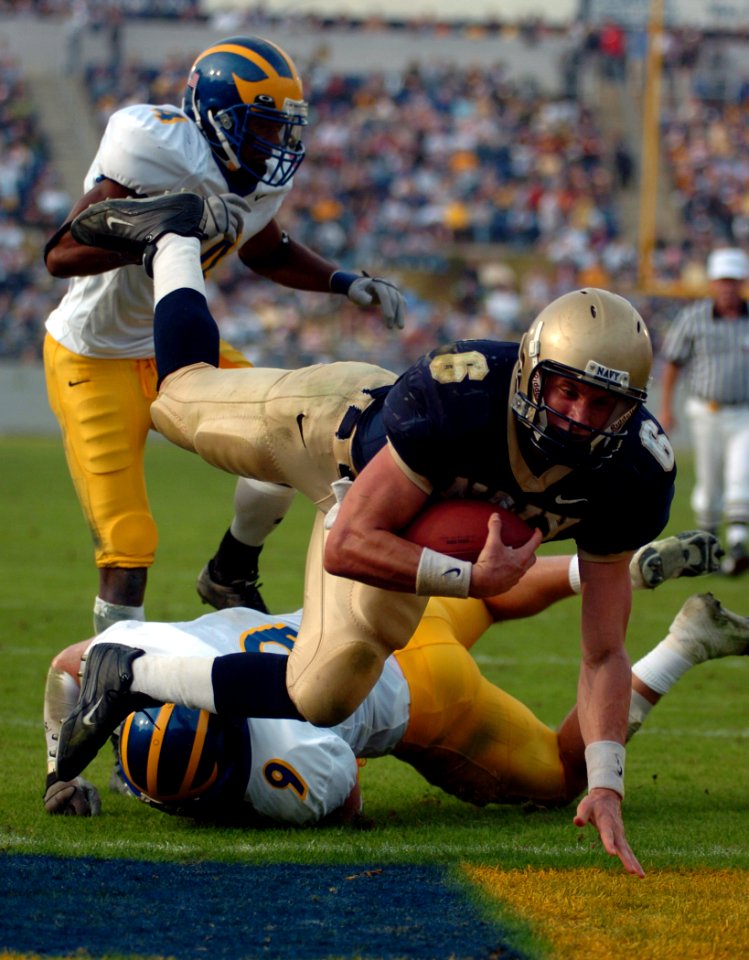 US Navy 041030-N-9693M-036 United States Naval Academy Midshipman Quarterback Aaron Polanco dives into the end zone for his second touchdown against the Delaware Blue Hens