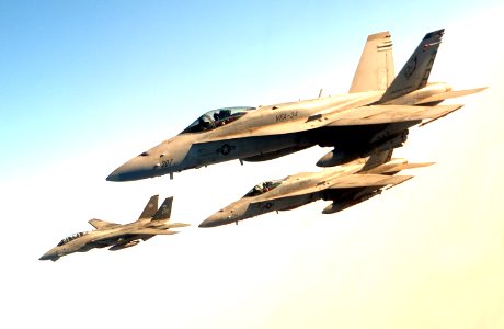 US Navy 040814-F-6740T-124 A pair of F-A-18C Hornets and an F-14B Tomcat fly in loose formation over Iraq