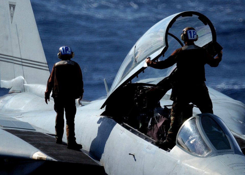 US Navy 041101-N-6363M-010 Airman Ashley Richie, left, and Aviation Structural Mechanic Airman Trent Goats, right, prepare an F-14B Tomcat for flight operations