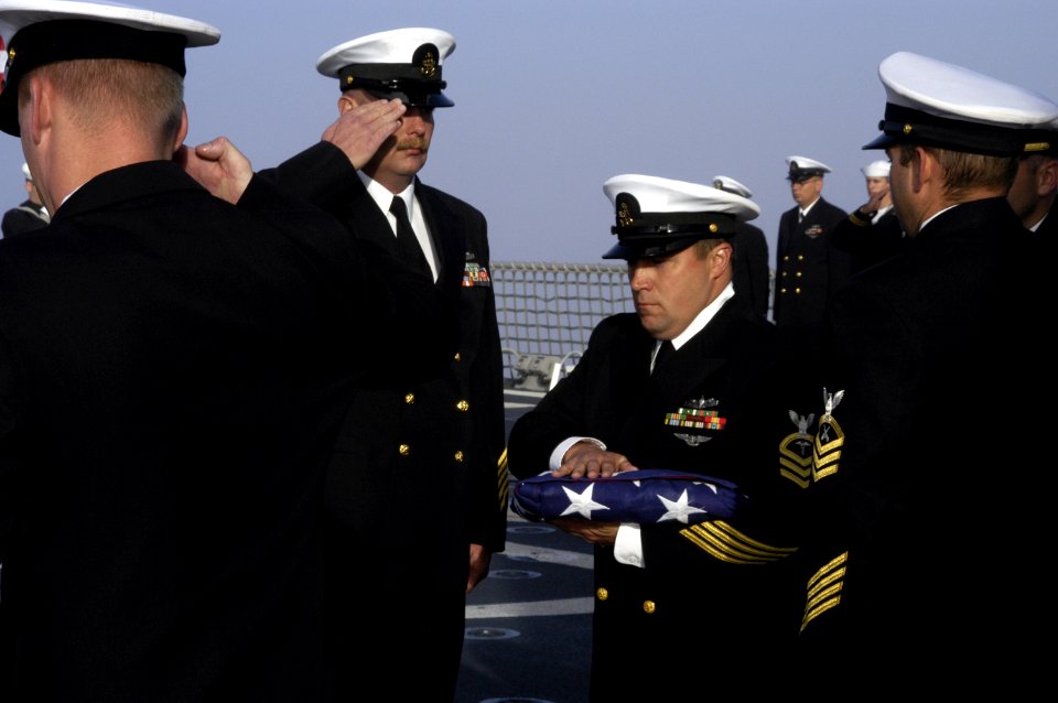 US Navy 041014-N-6477M-228 Chief Hospital Corpsman James Hopper and fellow chiefs assigned to USS Momsen (DDG 92), pay their final respects to four shipmates during a burial at sea