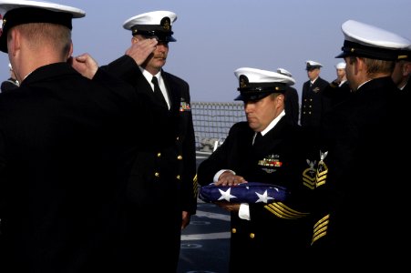 US Navy 041014-N-6477M-228 Chief Hospital Corpsman James Hopper and fellow chiefs assigned to USS Momsen (DDG 92), pay their final respects to four shipmates during a burial at sea