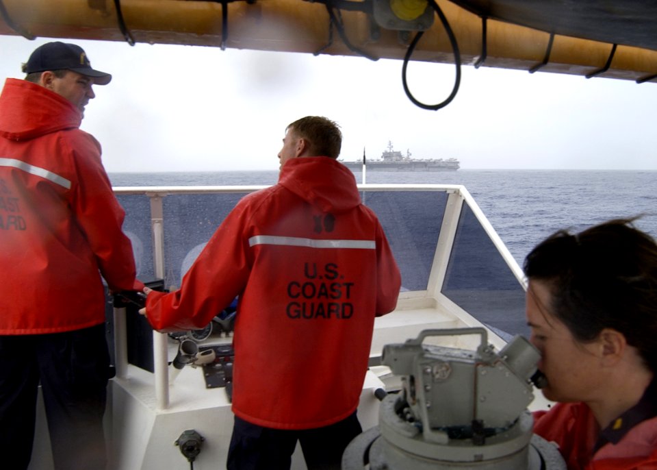 US Navy 040819-N-7293M-086 Lt. Jerome E. Dubay, Commanding Officer of the U.S. Coast Guard Cutter Galveston Island (WPB 1349), discuses the approach of the aircraft carrier USS Kitty Hawk (CV 63) with Lt. j.g. Collin MacInnes