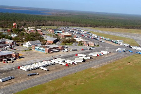 US Navy 040920-N-1234N-003 More than 100 tractor trailors, full of ice, food and water, are staged on the airfield at Naval Air Station Saufley Field, Fla., to assist Hurricane Ivan victims