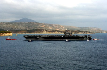 US Navy 041105-N-0780F-010 Tugboats pull along side the Nimitz-class aircraft carrier USS Harry S. Truman (CVN 75) as she enters Souda harbor in Crete, Greece, for a brief port visit