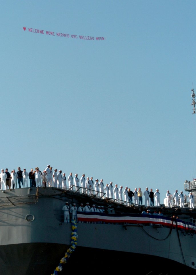 US Navy 041024-N-3925A-002 Sailors and Marines assigned to the amphibious assault ship USS Belleau Wood (LHA 3), man the rails as the ship enters Naval Station San Diego, Calif