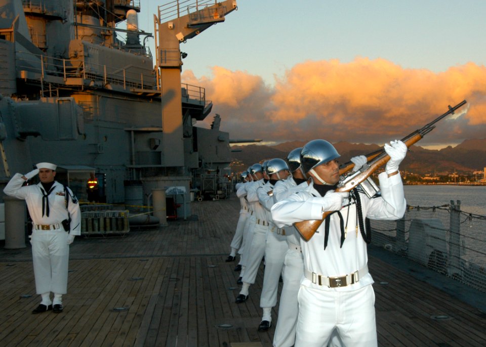 US Navy 041111-N-3019M-004 Ceremonial Color Guard, assigned to Naval Station Pearl Harbor, Hawaii, renders a 21-gun salute aboard the memorial battleship Missouri during a Veteran's Day sunset ceremony