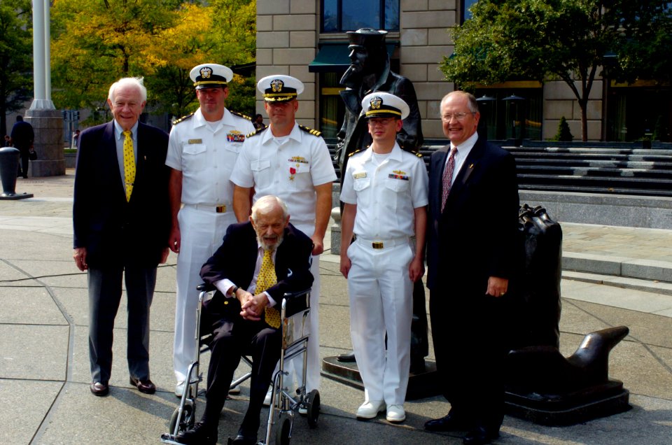 US Navy 040930-N-0295M-004 Cmdr. Michael Hegarty, center, stands with Former Secretary of the Navy Paul H. Nitze and friends after he was presented a Bronze Star at a ceremony held at the U.S. Navy Memorial in Washington, D.C