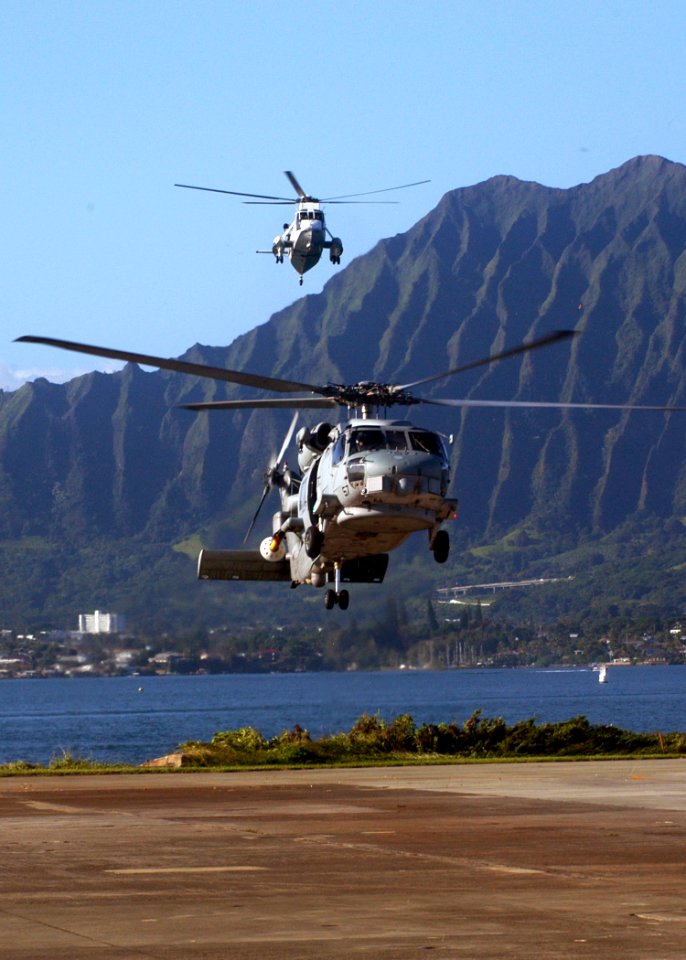 US Navy 041112-N-3019M-001 An SH-60B Seahawk helicopter assigned to the Easy Riders of Helicopter Anti-submarine Squadron Light Three Seven (HSL-37), arrives ahead of a UH-3H Sea King helicopter