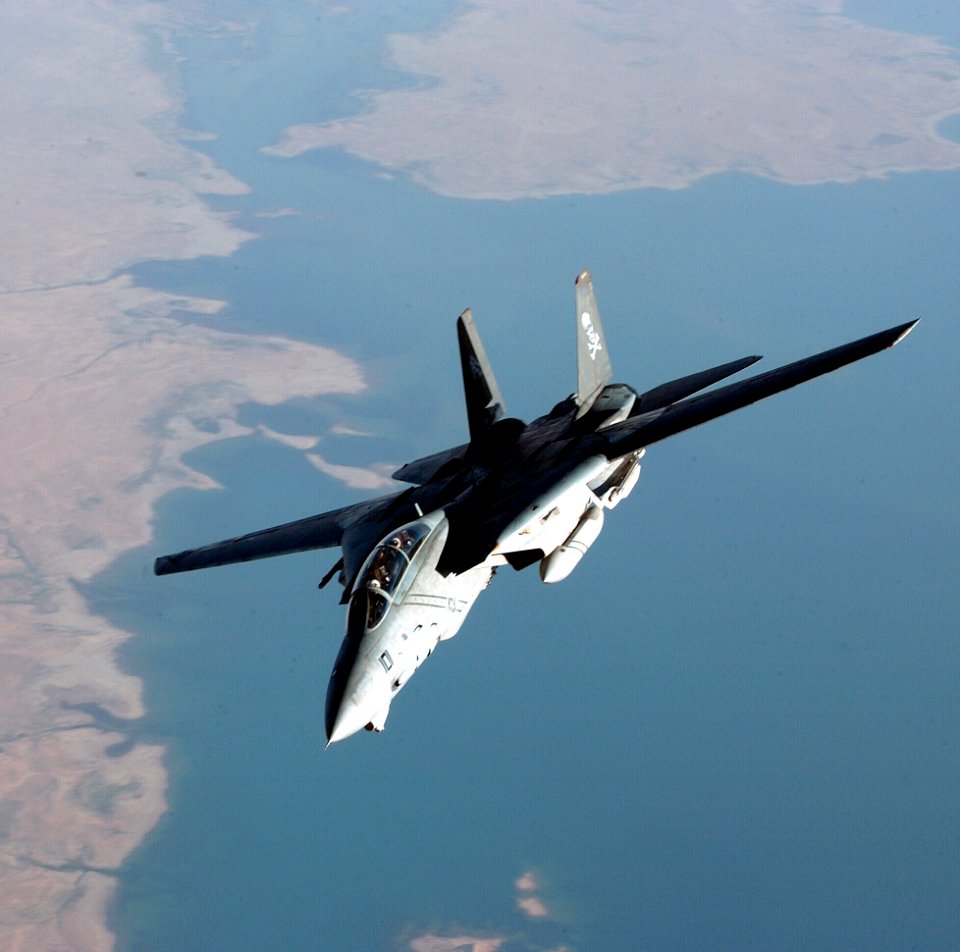 US Navy 041003-F-3188G-120 An F-14B Tomcat assigned to the Jolly Rogers of Fighter Squadron One Zero Three (VF-103), banks away from a U.S. Air Force KC-10 Extender