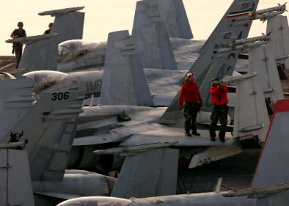 US Navy 041118-N-5345W-095 Two Aviation Ordnancemen assigned to the Gunslingers of Strike Fighter Squadron One Zero Five (VFA-105) make adjustments to an LAU-7 Guide Missile Launching mechanism