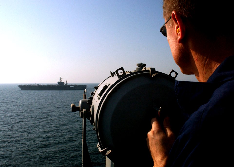 US Navy 041120-N-5345W-094 Chief Quartermaster Charles Baker sends signals via signal light from the Nimitz-class aircraft carrier USS Harry S. Truman (CVN 75) to Quartermasters aboard the conventionally powered aircraft carrie