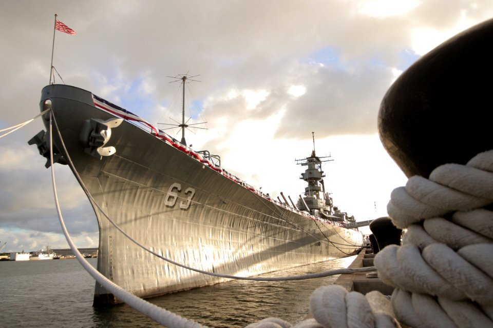 US Navy 041117-N-3228G-006 he decommissioned battleship USS Missouri (BB 63) is illuminated by the setting sun during a tribute ceremony for retired Chief Boatswain's Mate Harold B. Estes