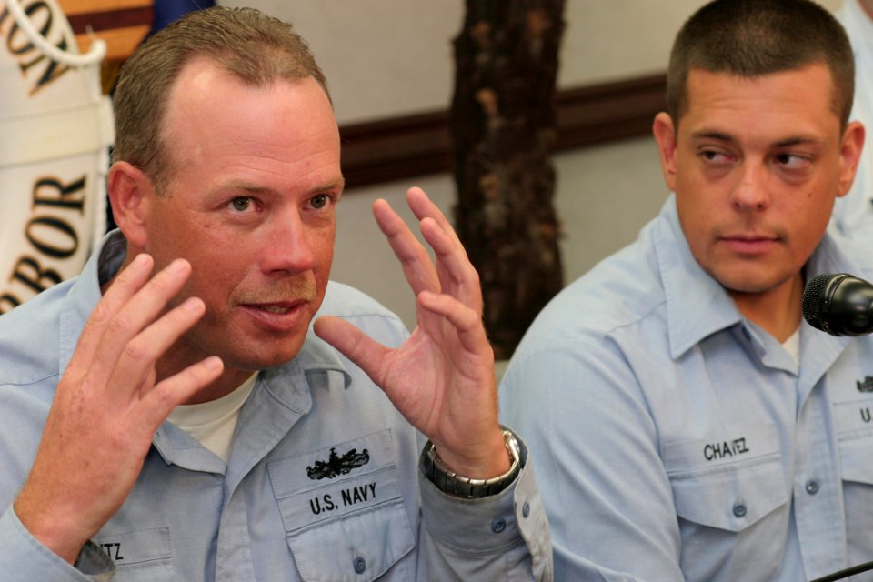 US Navy 041026-N-3228G-002 Hull Maintenance Technician 1st Class Martin Mantz of Center, N.D., left, and Hull Maintenance Technician 2nd Class Gary Chavez of Portage, Ind., talk to reporters at a press conference about their re