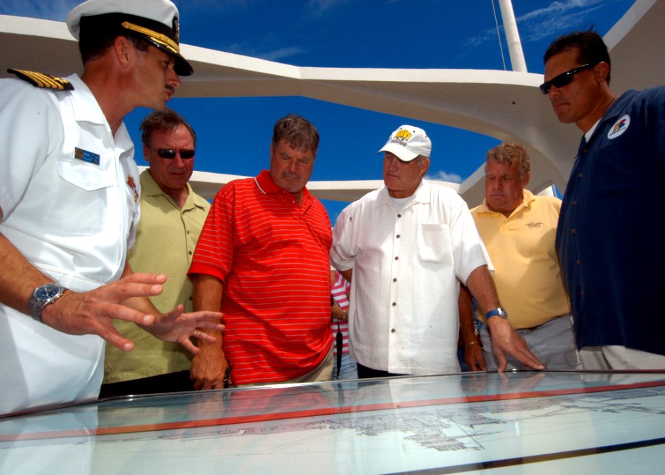 US Navy 040902-N-3019M-004 Capt. Michael C. Vitale, commander, Navy Region Hawaii and commander, Naval Surface Group Middle Pacific, explains the events surrounding the attack on Pearl Harbor to National Football League (NFL) H