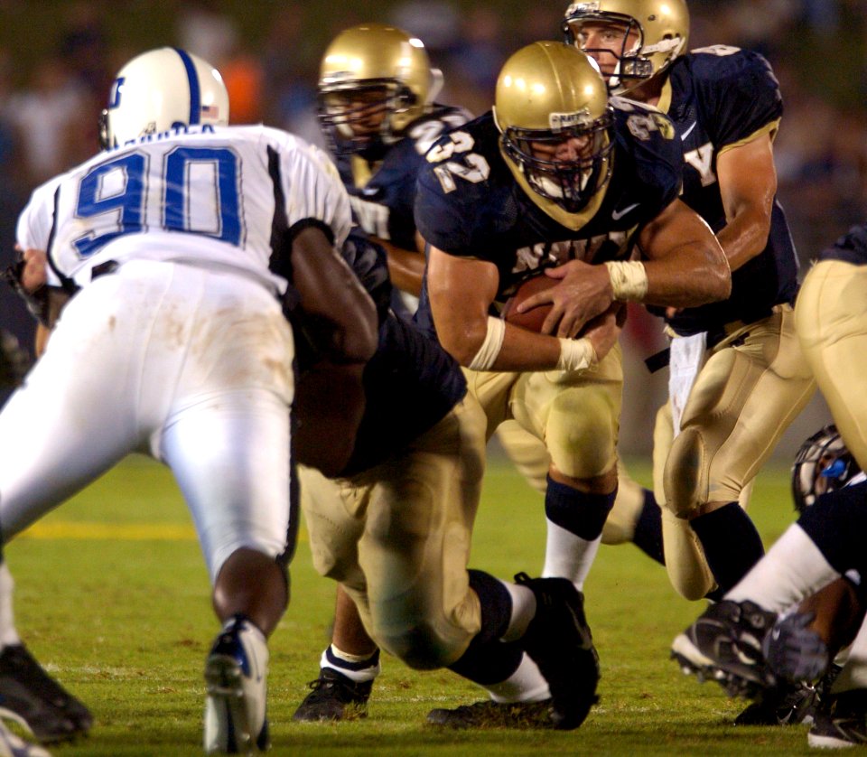 US Navy 040904-N-9693M-009 U.S. Naval Academy Midshipman 1st Class Kyle Eckel runs for a touchdown against the Duke Blue Devils