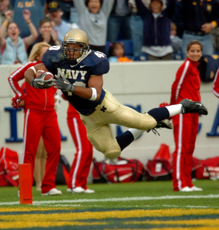 US Navy 041120-N-9693M-010 U.S. Naval Academy Midshipman 3rd Class David Mahoney leaps across the goal line to score the third Navy touchdown against Rutgers University in the 1st quarter of play