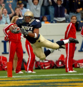 US Navy 041120-N-9693M-010 U.S. Naval Academy Midshipman 3rd Class David Mahoney leaps across the goal line to score the third Navy touchdown against Rutgers University in the 1st quarter of play