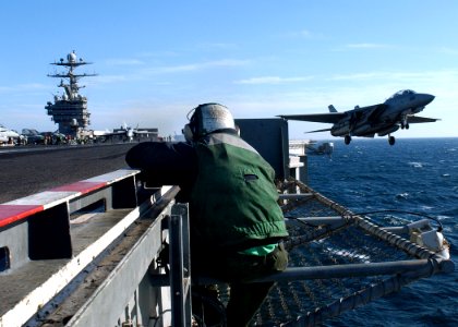 US Navy 041125-N-5345W-045 A bow safety watch stander observes an F-14B Tomcat assigned to the Swordsmen of Fighter Squadron Three Two (VF-32), during a launch from the waist catapult aboard the Nimitz-class aircraft carrier US