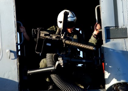 US Navy 041031-N-5345W-058 A door gunner aboard an SH-60 Seahawk prepares for landing aboard USS Harry S. Truman (CVN 75)