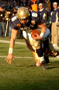 US Navy 041204-N-9693M-008 Navy Quarter Back Aaron Polanco scores for Navy at the 105th Army Navy game