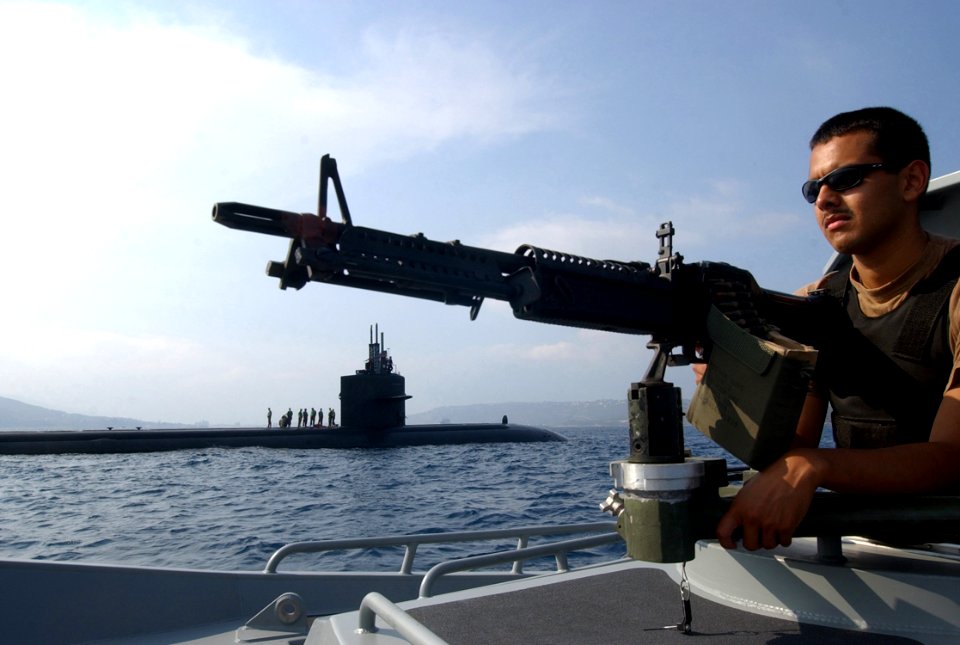 US Navy 041025-N-0780F-036 Master-at-Arms Seaman Alejandro Maldonado of Los Angeles, Calif., mans a 7.62mm M-60 machine gun on the bow of a 36-foot patrol boat