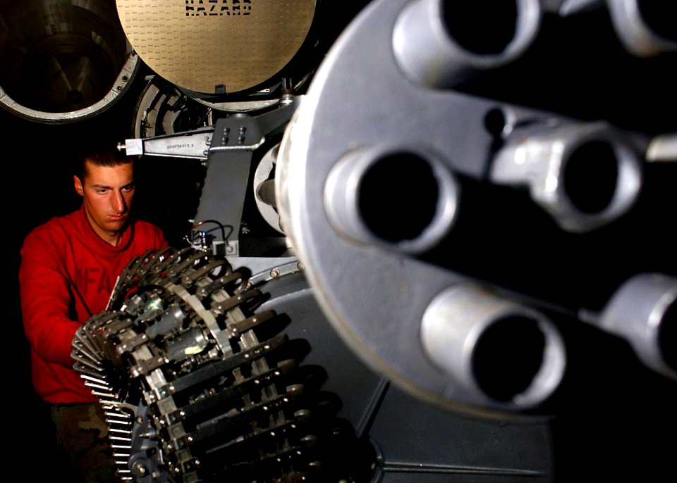 US Navy 041129-N-5345W-036 Aviation Ordnanceman 2nd Class Douglas Vanstrien performs routine maintenance on an M61A1 20mm Vulcan cannon