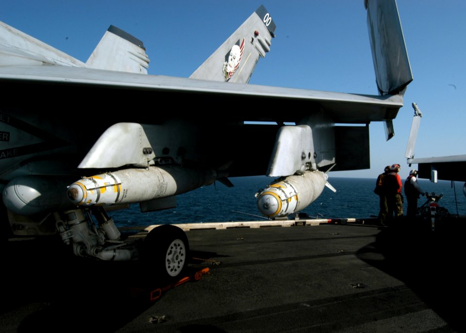 US Navy 041106-N-8704K-003 The portside wing on an F-A-18 assigned to the Blue Blasters of Strike Fighter Squadron Three Four (VFA-34) is loaded with the Navy's latest Satellite Guided Bomb, the GBU-38