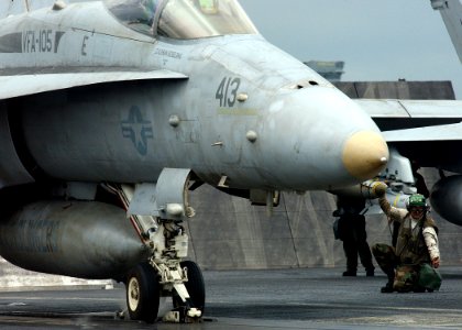 US Navy 041201-N-5345W-005 Aviation Structural Mechanic 3rd Class Aaron Kinnison assigned to the Gunslingers of Strike Fighter Squadron One Zero Five (VFA-105), gives the clear to launch signal