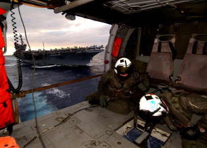 US Navy 041206-N-4374S-005 Aircrewmen prepare to receive a cargo pallet from the fast combat support ship USS Seattle (AOE 3) during a vertical replenishment at sea as the conventionally powered aircraft carrier USS John F. Ken
