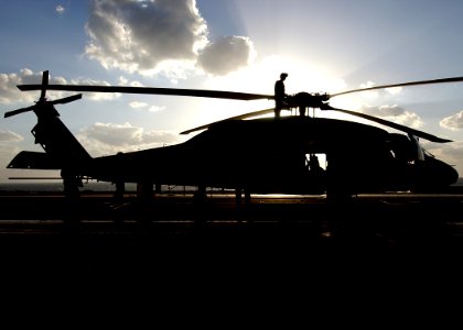 US Navy 041202-N-5345W-017 Sailors, assigned to the Dusty Dogs of Helicopter Anti-Submarine Squadron Seven (HS-7), take advantage of a no-fly day to perform routine maintenance