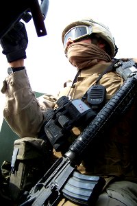 US Navy 041116-N-1438S-001 Construction Electrician Constructionman Gabriel Pena of Santa Ana, Calif., mans a turret gun in a Seabee Engineer Reconnaissance Team (SERT) team convoy in Fallujah, Iraq