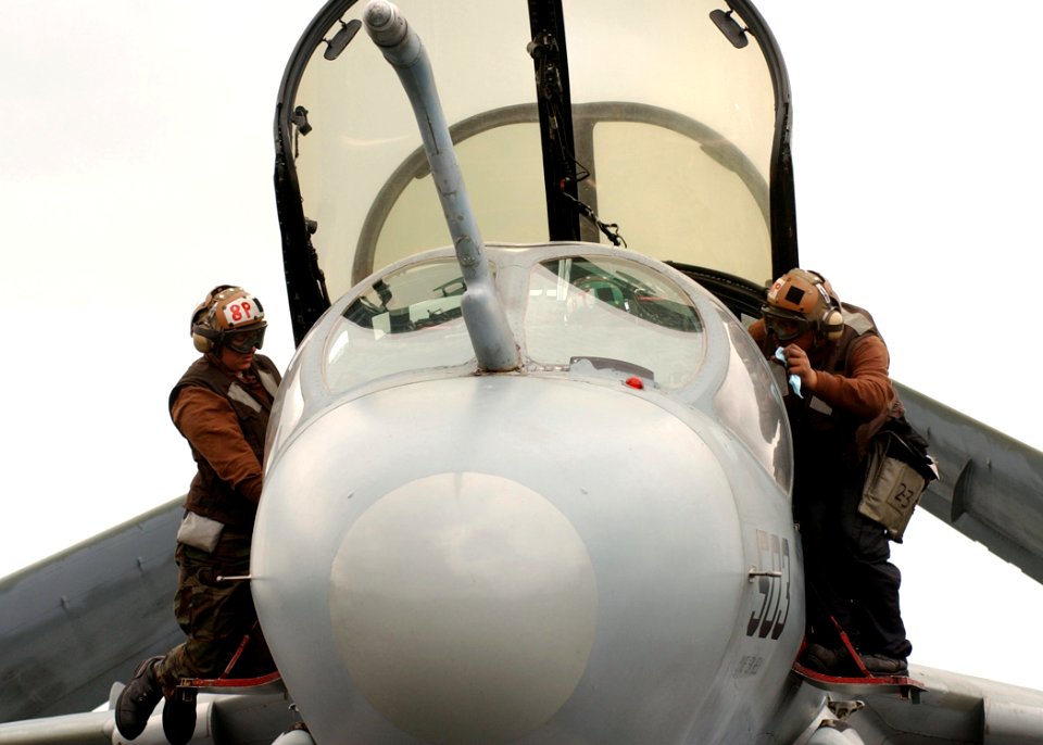 US Navy 041209-N-6363M-012 Airman Marcee Davis (left) and Airman Sylvia Rodriguez assigned to the Zappers of Electronic Attack Squadron One Three Zero (VAQ-130), conducts a preflight check on an EA-6B Prowler