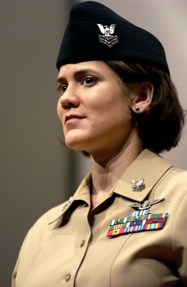 US Navy 041208-N-0962S-116 Yeoman 1st Class Erin Morgan stands at attention as she models the khaki option of the year-round concept service uniform for Sailors E-6 and below