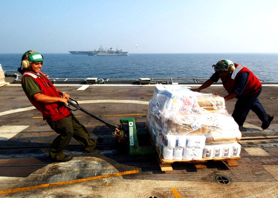 US Navy 041112-N-4374S-007 Sailors assigned to the Proud Warriors of Helicopter Anti-Submarine Squadron Light Four Two (HSL-42), move a pallet of stores across the flight deck of the guided missile cruiser USS Vicksburg (CG 69)