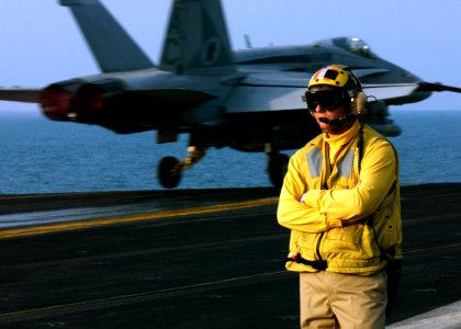 US Navy 041121-N-5345W-054 Chief Aviation Boatswain's Mate Jeffrey Brownlee observes flight deck operations as an F-A-18C Hornet launches from the flight deck aboard the Nimitz-class aircraft carrier USS Harry S. Truman (CVN 75