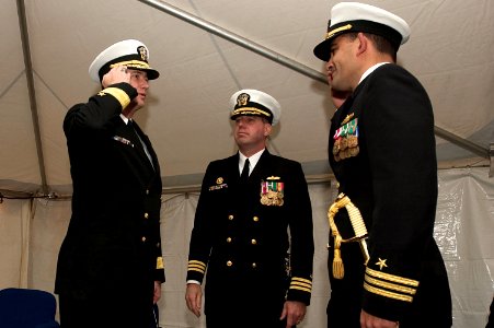 US Navy 041109-N-6477M-023 Cmdr. Timothy B. Spratto, right, renders a hand salute to Commander, Navy Region Northwest, Rear Adm. Hering during a change of command ceremony at Naval Station Everett