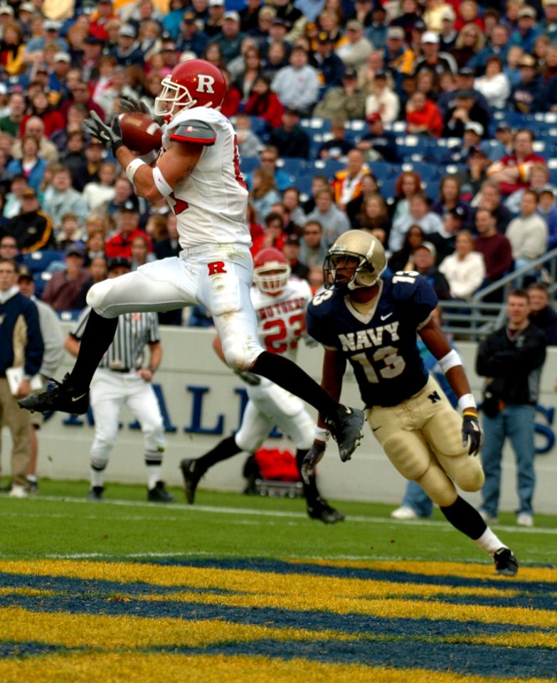 US Navy 041120-N-9693M-006 Rutgers University tight end Clark Harris catches a pass from quarterback Ryan Hart under coverage by U.S. Naval Academy Midshipman 3rd Class Hunter Reddick