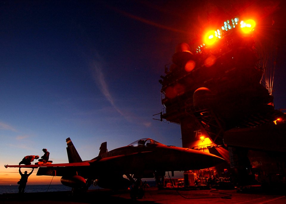 US Navy 041211-N-4308O-021 Marines assigned to the Silver Eagles of Marine Fighter Attack Squadron One One Five (VMFA-115) perform maintenance on an F-A 18A- Hornet after flight operations aboard the USS Harry S. Truman (CVN 75