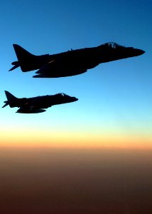US Navy 041003-F-3188G-247 A pair of U.S. Marine Corps AV-8B Harriers fly over Iraq at sunset during a mission in support of Operation Iraq Freedom (OIF)